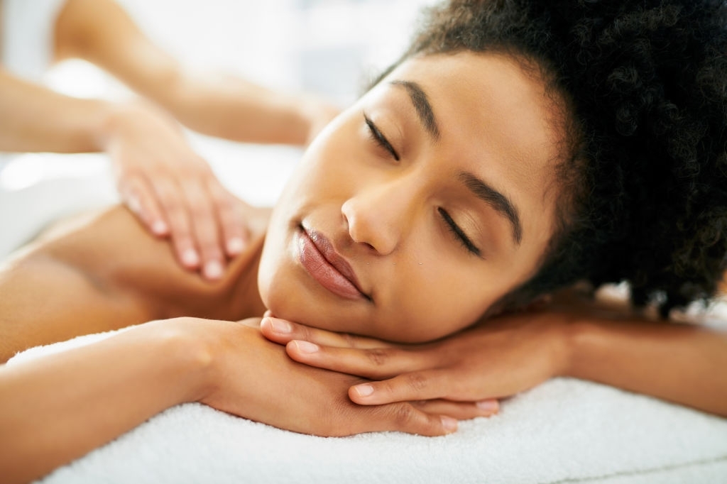 Pain Relief - Shot of an attractive young woman getting a massage at a spa