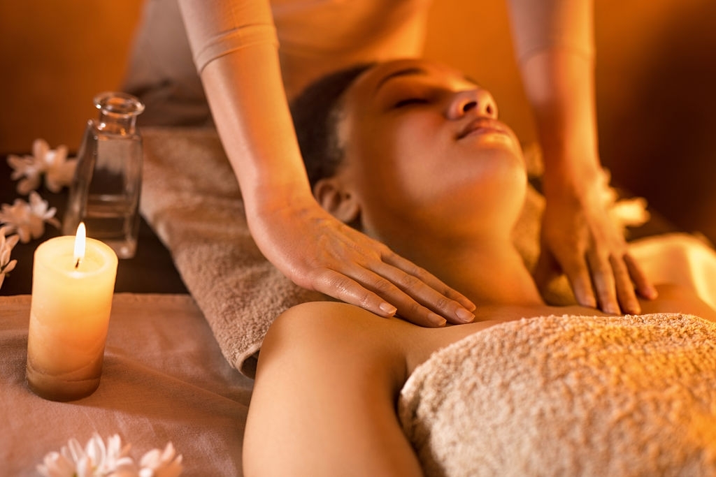 Seek Faster Relief - Close-up of African American woman relaxing at the spa during shoulder massage.