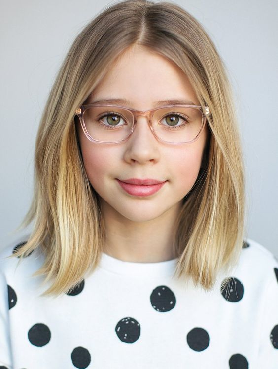 An 11 Year Old girl with Bob Haircut wearing specs