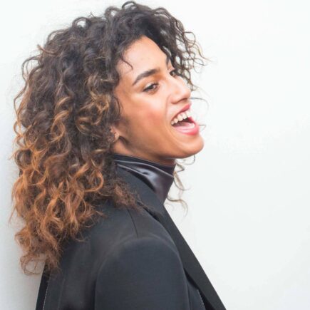 black curly hair with blonde highlights