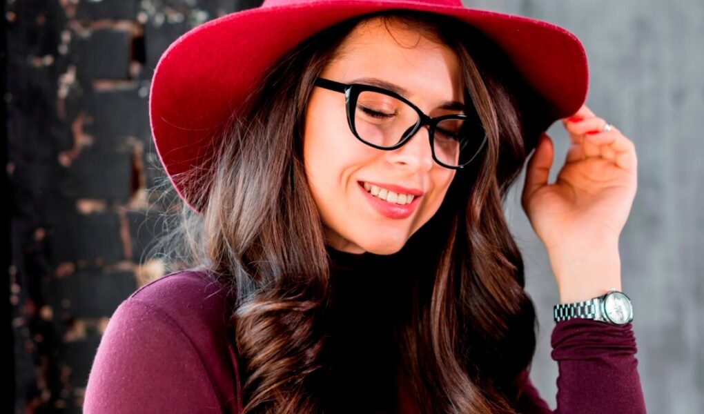 portrait smiling beautiful young woman with pink hat black eyeglasses 1
